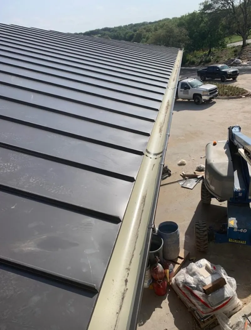 Standing seam panel and gutter detail on a metal roofing jobsite in Richmond
